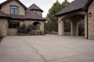 Standard concrete driveway before paver installation at Denver home