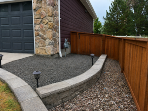 Low maintenance landscaping with natural rocks, mulch, and defined borders in Denver